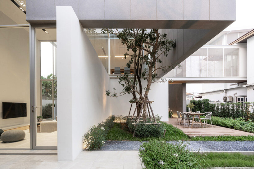 four miniature courtyards bring nature inside this secluded family house in thailand