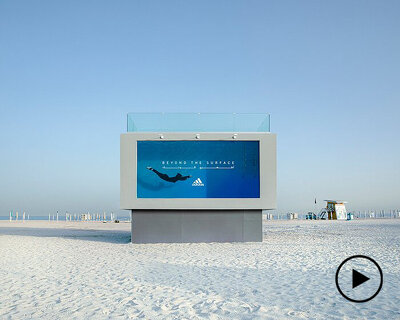 you can literally dive into adidas’ first-ever liquid billboard in dubai