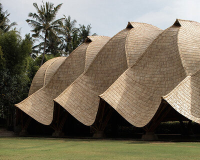 draping roof tops intricate bamboo structure by IBUKU for green school in bali, indonesia