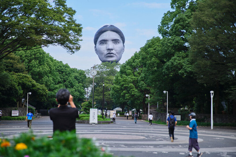 giant balloon head floats over tokyo