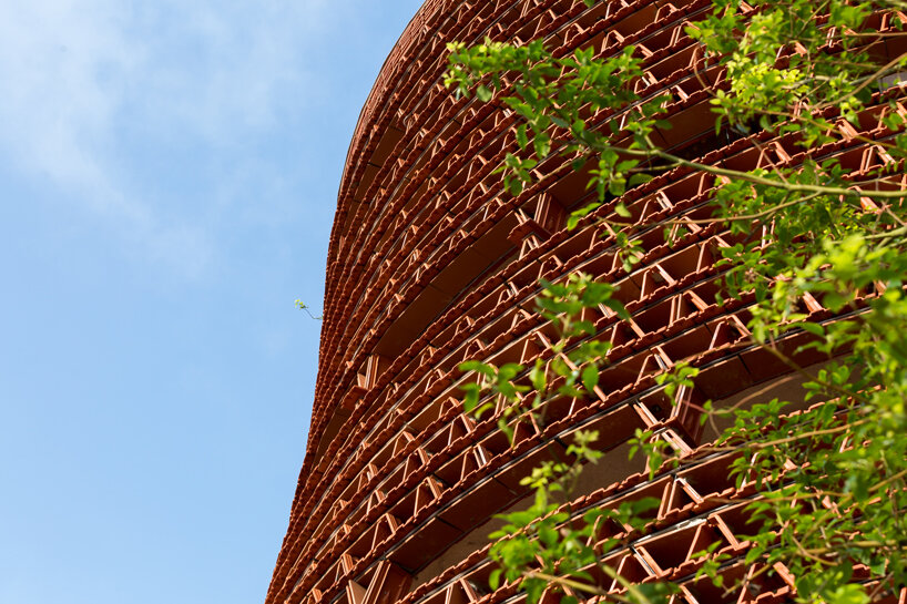H&P architects wraps 20,000 tiles around 'ngói space' in hanoi, vietnam designboom