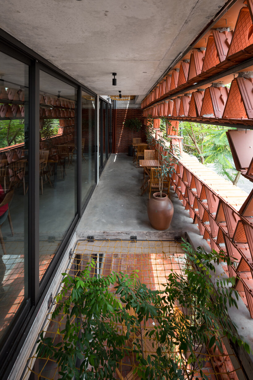 H&P architects wraps 20,000 tiles around 'ngói space' in hanoi, vietnam designboom