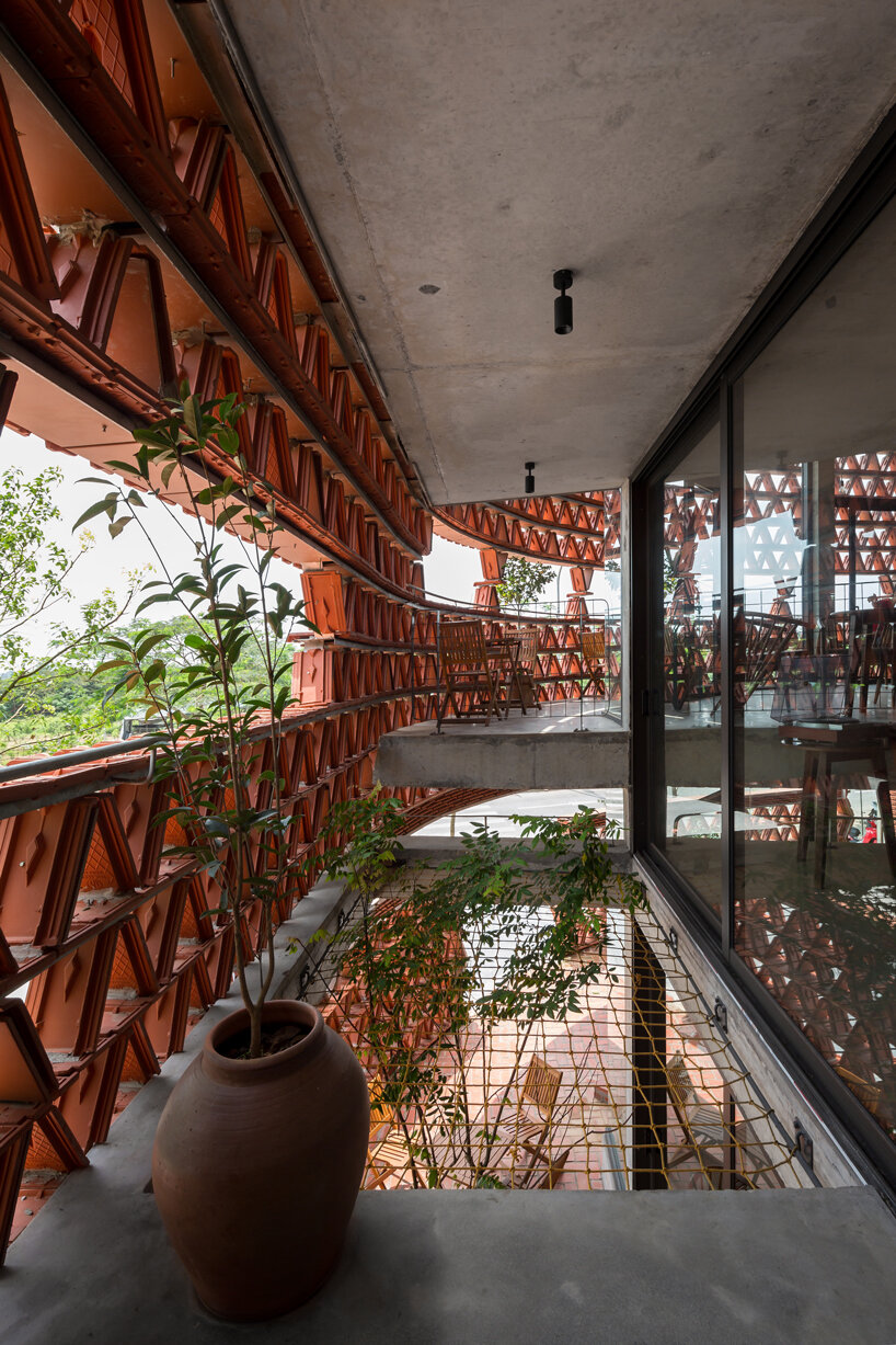H&P architects wraps 20,000 tiles around 'ngói space' in hanoi, vietnam designboom