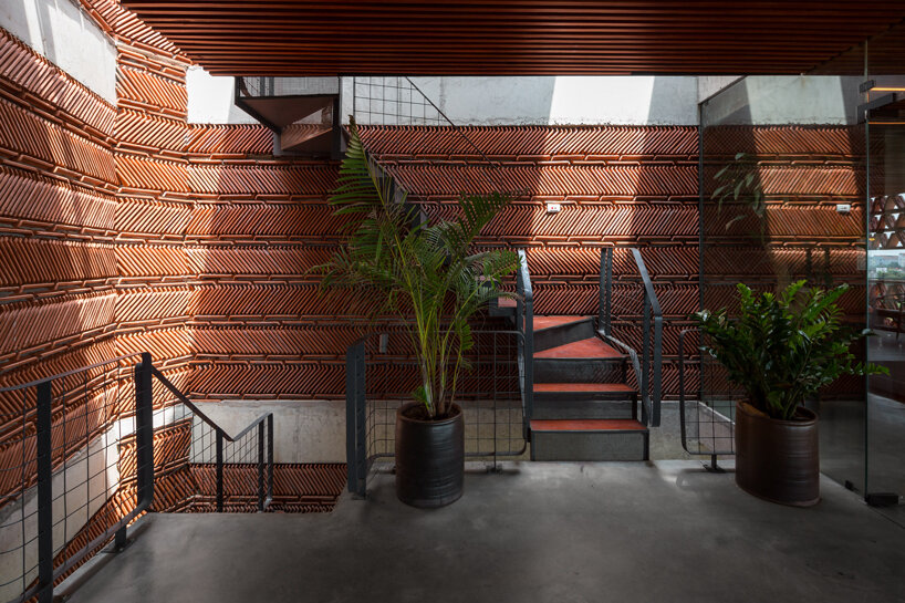 H&P architects wraps 20,000 tiles around 'ngói space' in hanoi, vietnam designboom