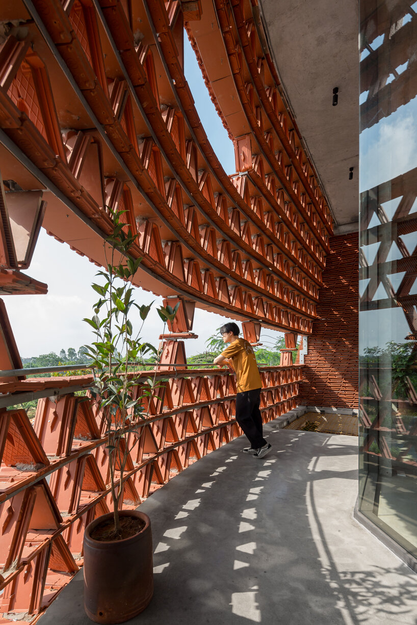H&P architects wraps 20,000 tiles around 'ngói space' in hanoi, vietnam designboom