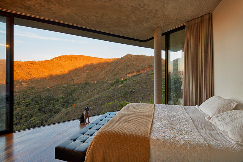 tetro tops residence with irregular deck roof opening towards mountainous views in brazil