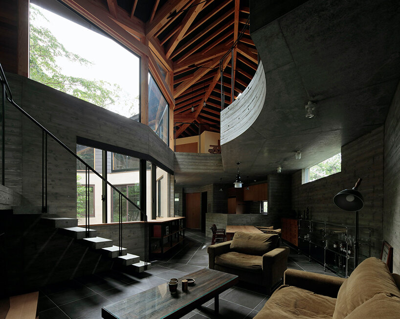 irregular-angled 'phase dance' residence by takeshi hirobe wraps around a large tree in japan