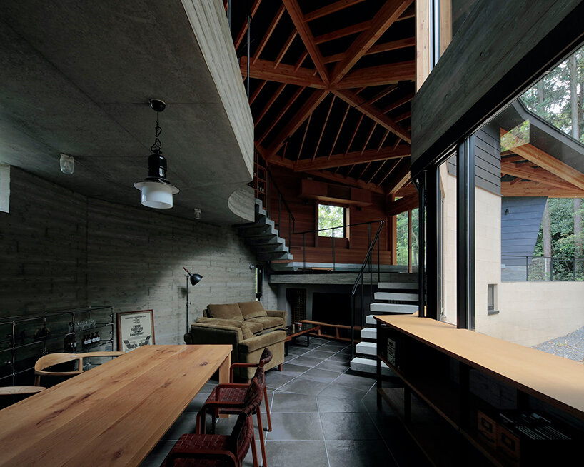 irregular-angled 'phase dance' residence by takeshi hirobe wraps around a large tree in japan