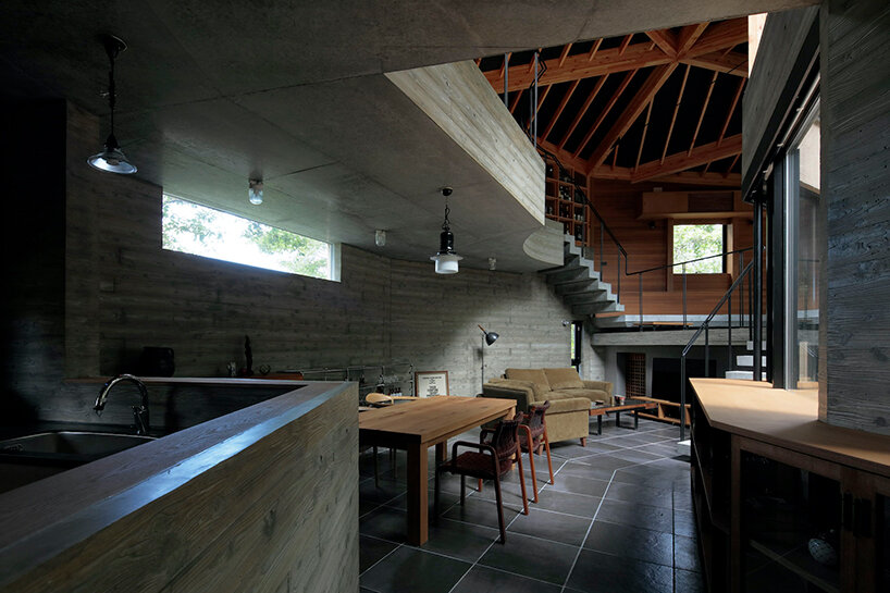 irregular-angled 'phase dance' residence by takeshi hirobe wraps around a large tree in japan