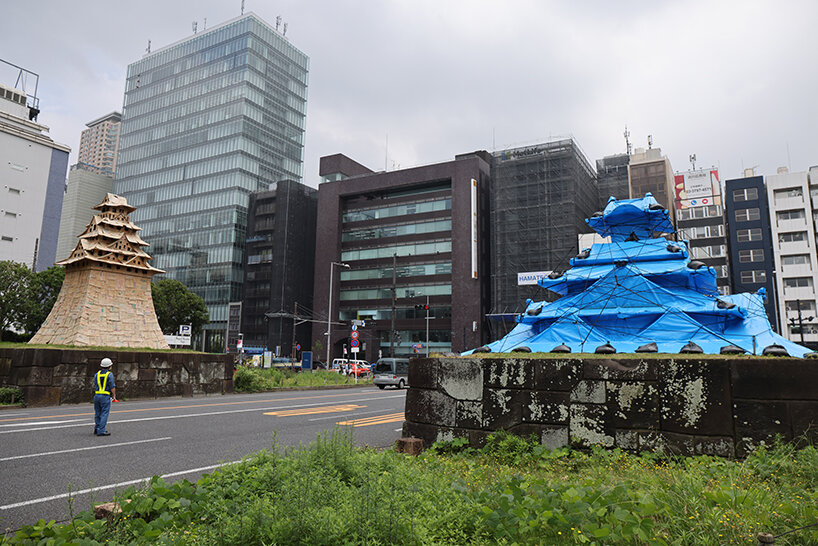 cardboard + blue tarp castle by makoto aida stands out in tokyo to emphasize temporariness