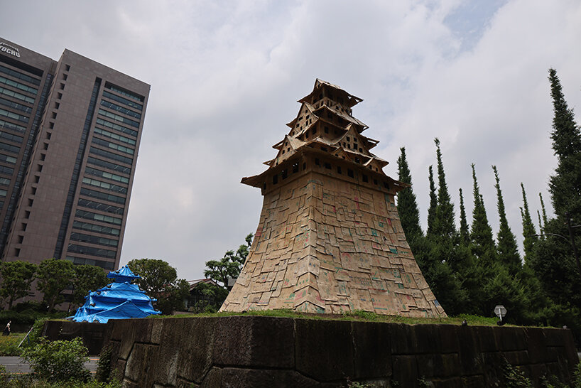 cardboard + blue tarp castle by makoto aida stands out in tokyo to emphasize temporariness