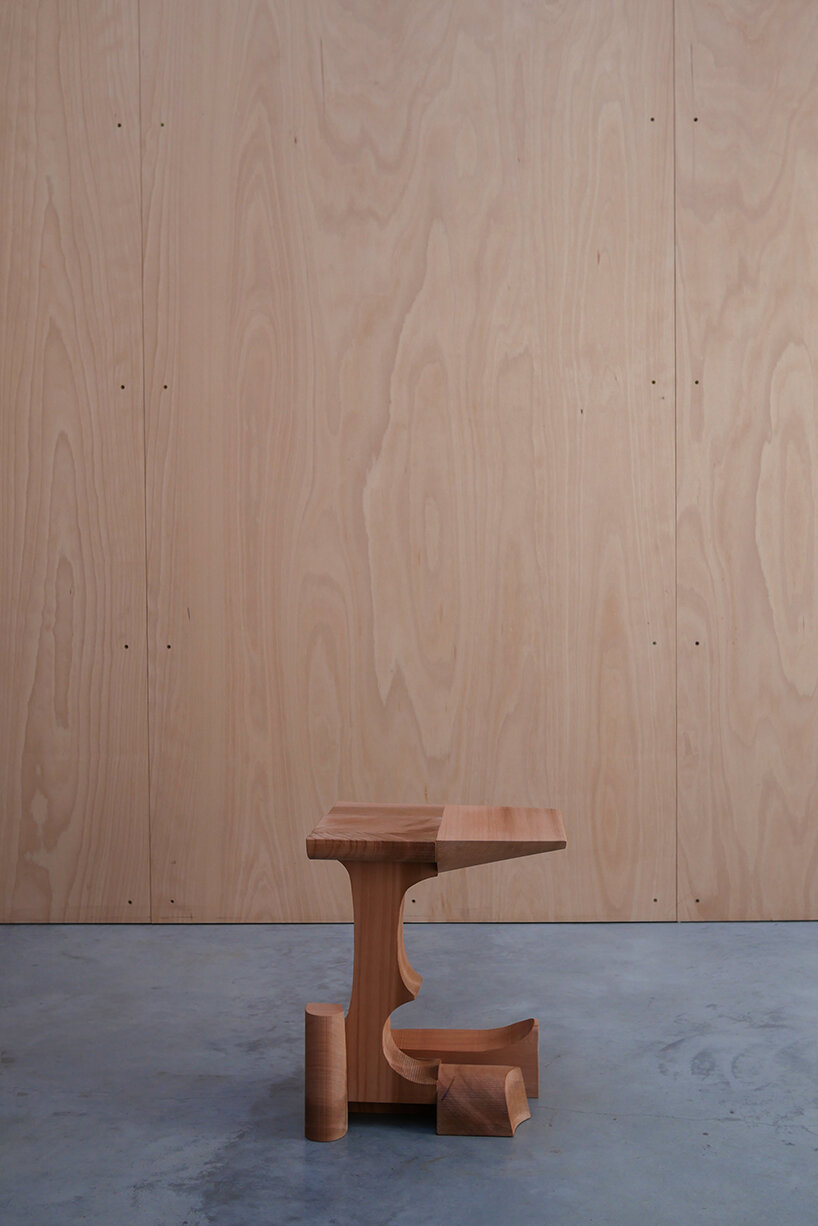 max lamb exhibits puzzle-like wooden furniture along chairs in stone at salon 94 design