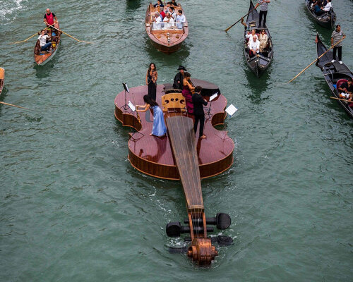 giant violin floats down venice's grand canal complete with string quartet
