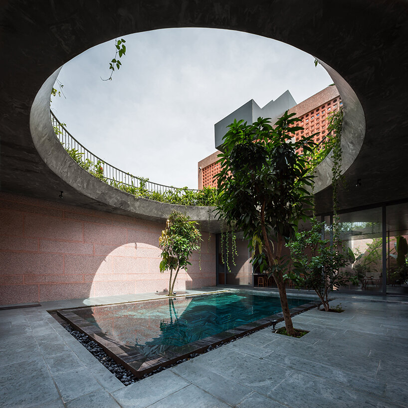 large circular roof opening punctures 23o5 studio's pink house in vietnam