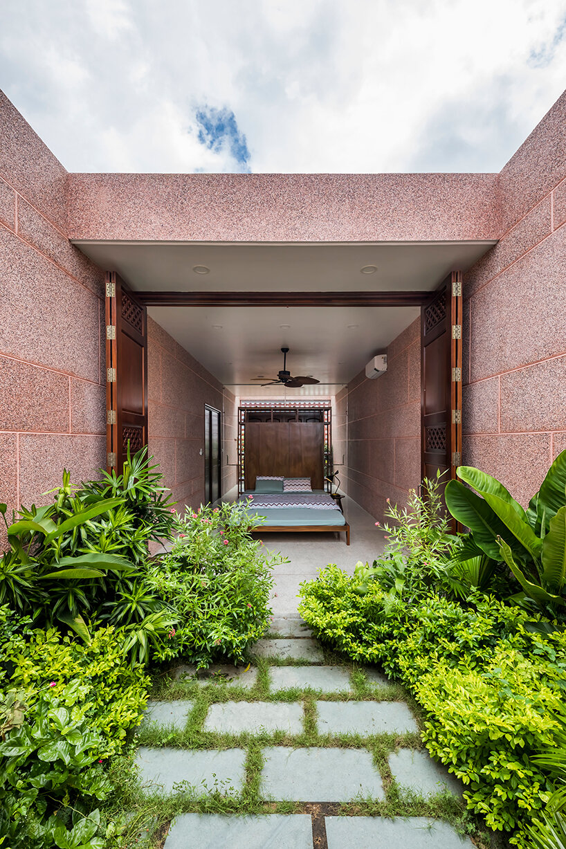 large circular roof opening punctures 23o5 studio's pink house in vietnam