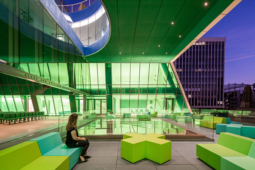 a trapezoidal room and terrace frame the arched stained-glass windows of the historic temple