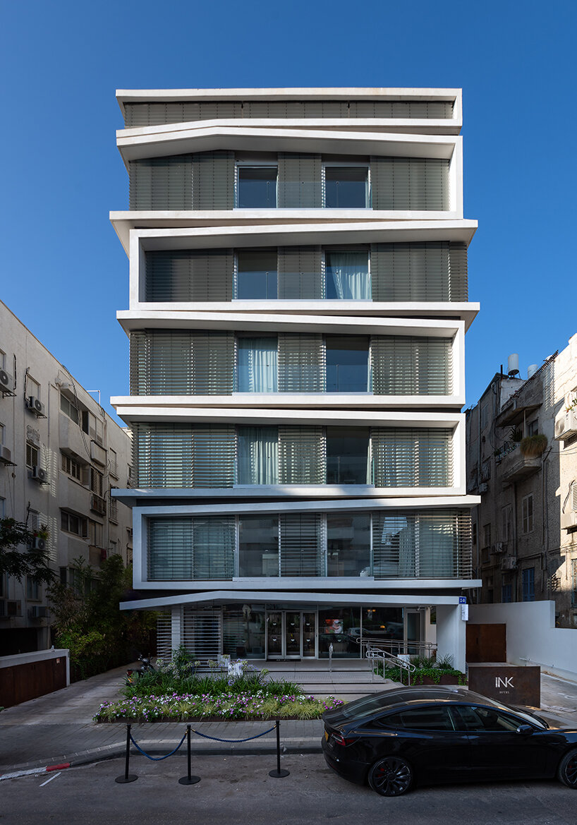 ink hotel emerges as a pile of stacked books in the heart of tel aviv, israel
