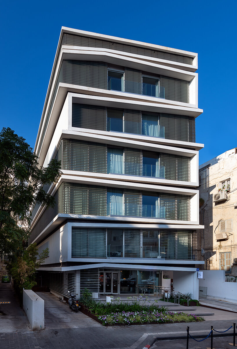 ink hotel emerges as a pile of stacked books in the heart of tel aviv, israel