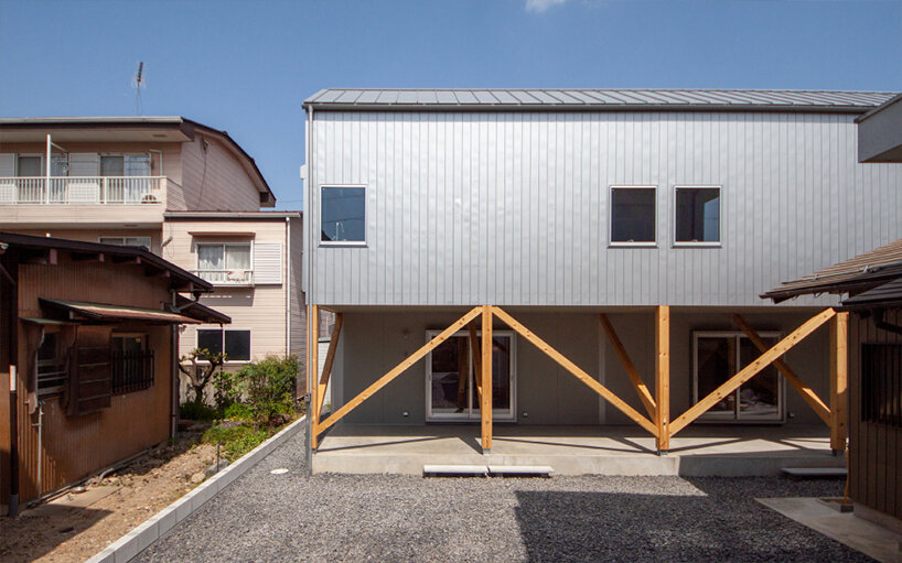 midorichio house in japan emerges from wooden skeleton forming a piloti