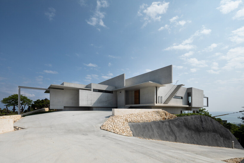 concrete hilltop villa by kidosaki architects studio overlooks the pacific ocean in japan