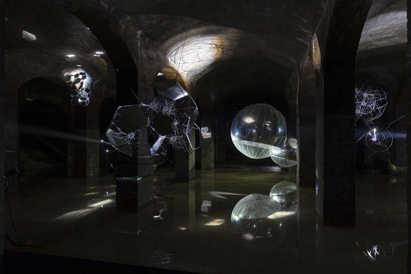 luminous spheres hover within tomás saraceno's floating exhibition in cisternerne