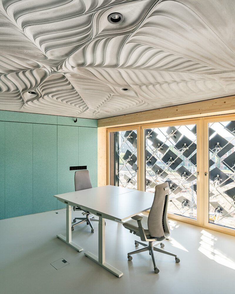 the office space on the east side with a view of the adaptive solar façade and the bottom surface of the lightweight floor construction - image by roman keller