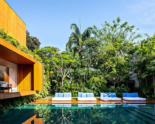 an ensemble of imposing blocks organized around a pool forms ibsen house in brazil