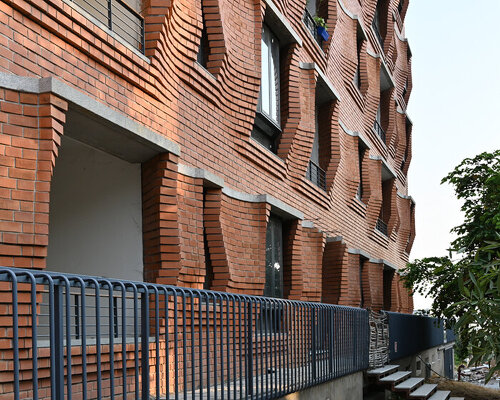 sP+a wraps its sienna apartments in a facade of rippling brickwork