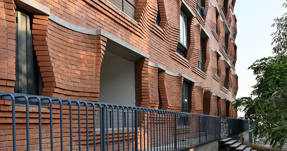 sP+a wraps its sienna apartments in a facade of rippling brickwork