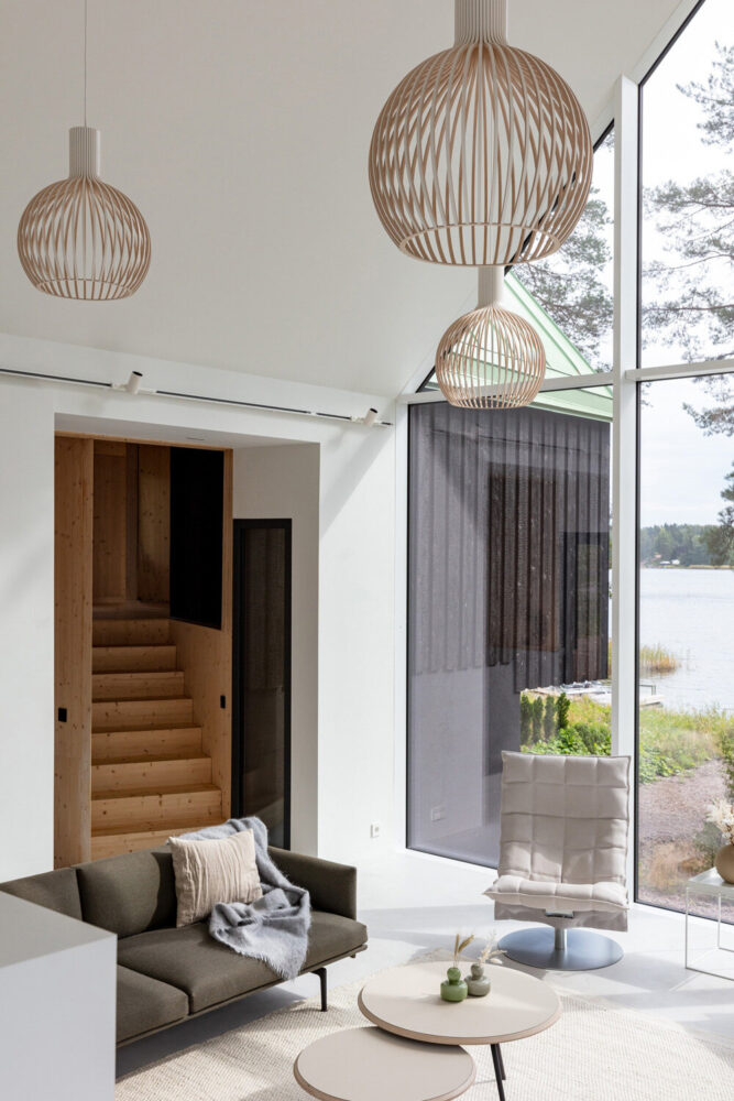 pirinen & salo sets threevolume charred wood house between pine trees