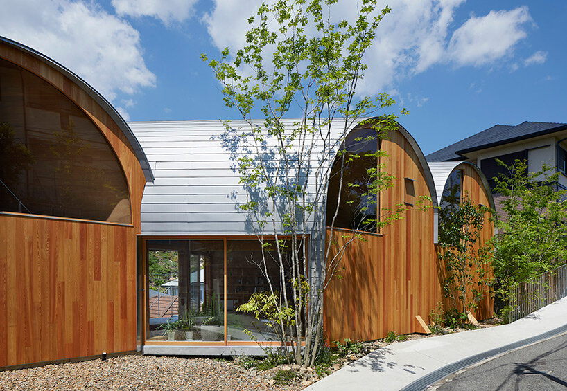 a series of tilted vaulted roofs tops wooden house by tomohiro hata in koyoen, japan
