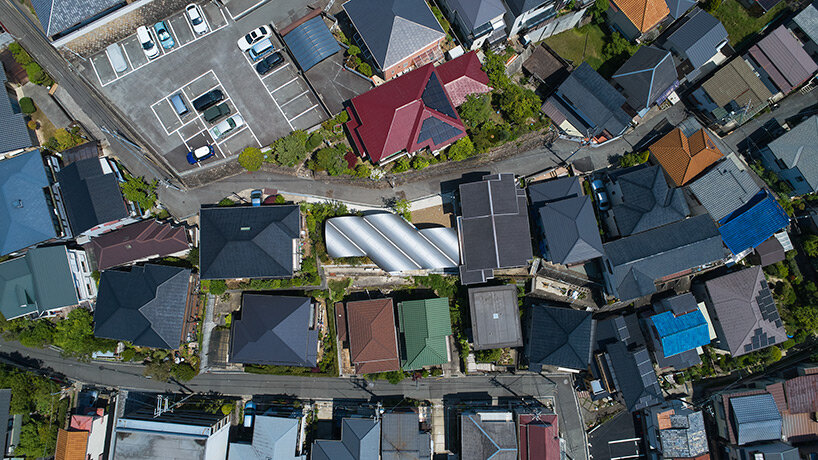 a series of tilted vaulted roofs tops wooden house by tomohiro hata in koyoen, japan
