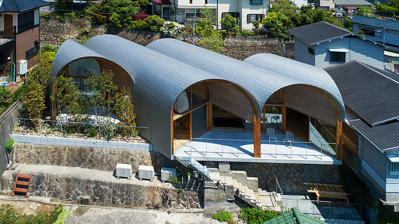 a series of tilted vaulted roofs tops wooden house by tomohiro hata in koyoen, japan