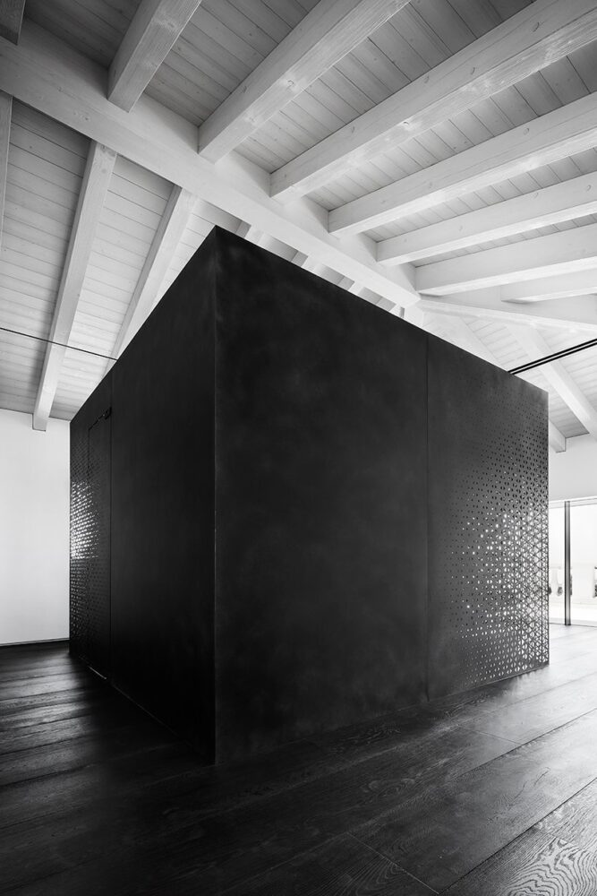 a standalone metal cube incorporates the steam room and bathroom