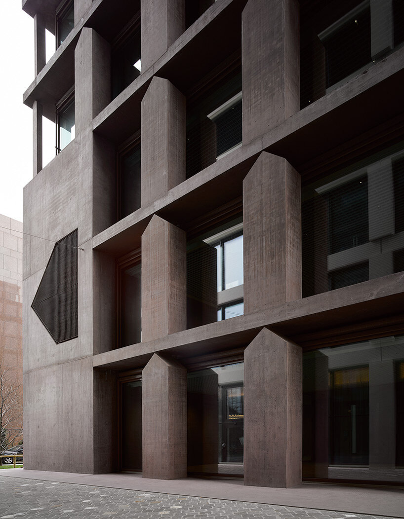 reocurring house-shaped elements articulate concrete office tower by valerio olgiati in switzerland