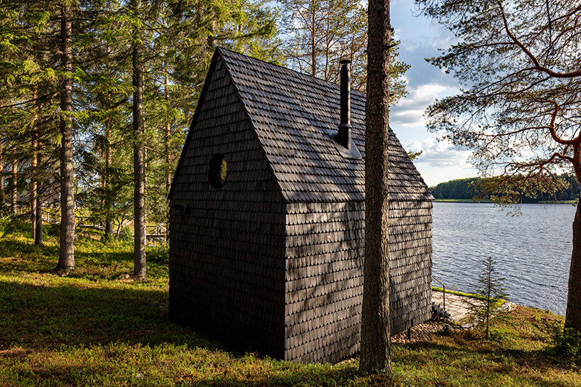 pirinen & salo clad the filmmakers hut in finland with tar-coated shingles
