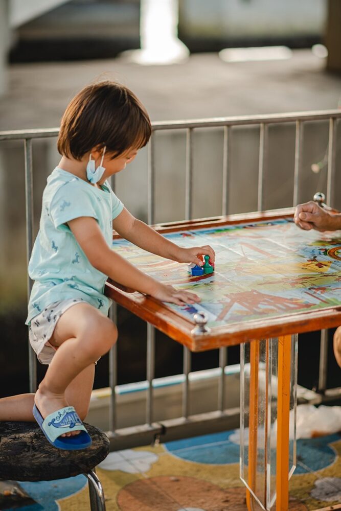 retro mahjong table upcycled to board game play table anchored to existing bench