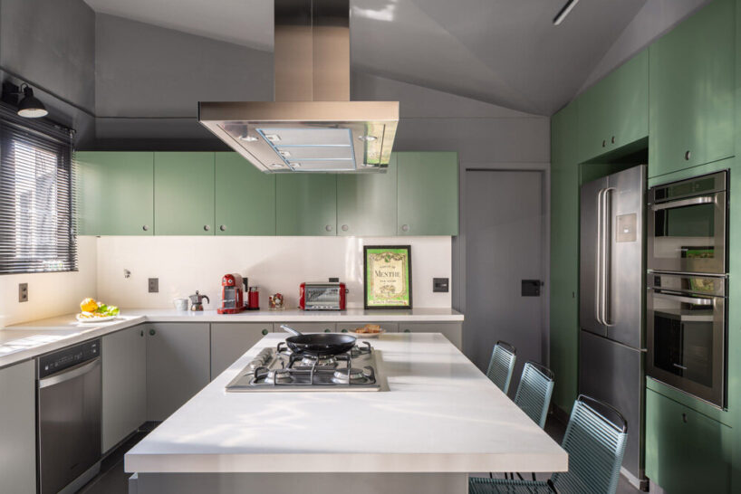 the green kitchen brings a pop of color to the interior