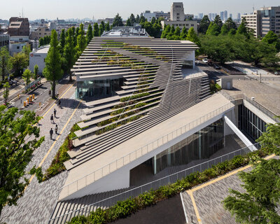 kengo kuma encloses this underground student center with a stepping green roof