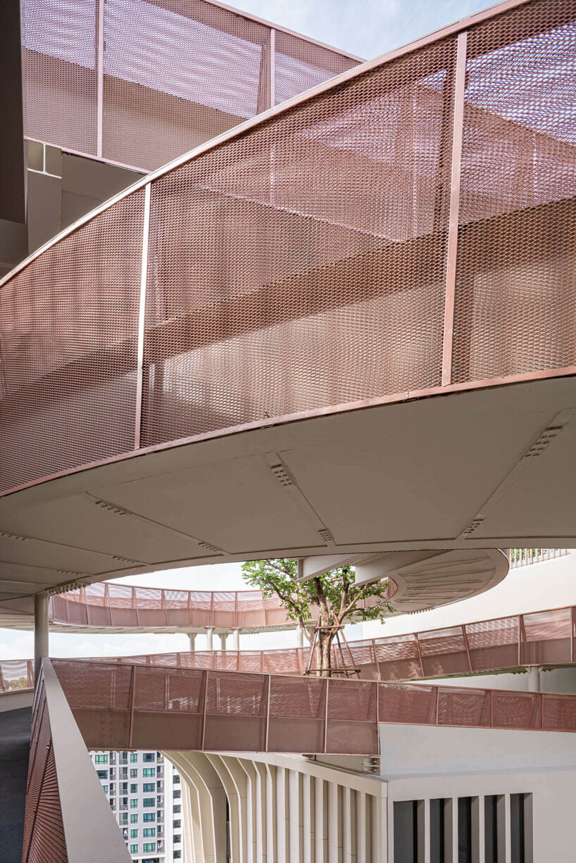 openbox architects inserts rose gold spiral ramp between two residential towers in bangkok