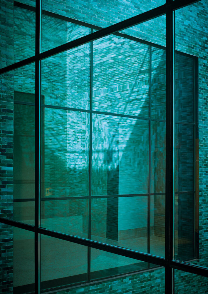 view of the square courtyard through the picture windows of the great hall. image © dan glasser (page 248)