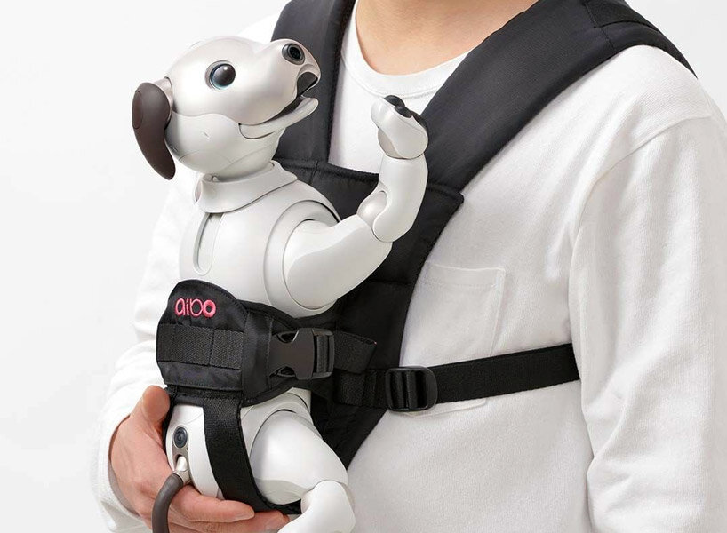sony’s puppy robot can now be carried with its new sling that resembles a baby carrier