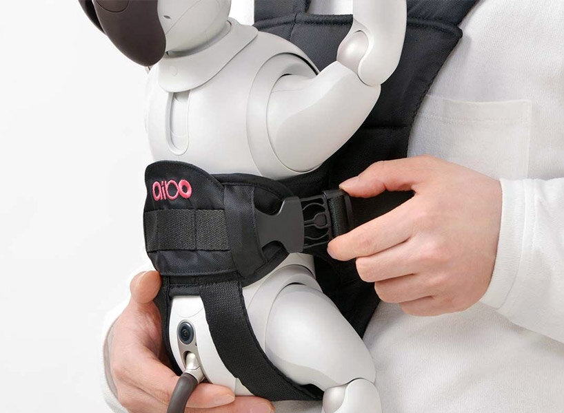 sony’s puppy robot can now be carried with its new sling that resembles a baby carrier