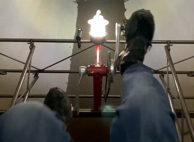 a bike inside a tunnel: artist fernando abellanas pedals through a sewer with ‘enlace’