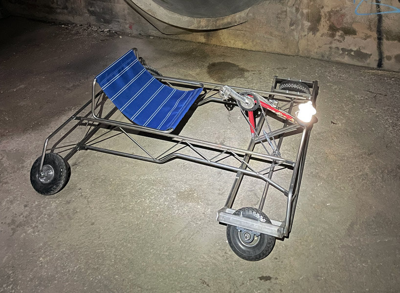 a bike inside a tunnel: artist fernando abellanas pedals through a sewer with ‘enlace’