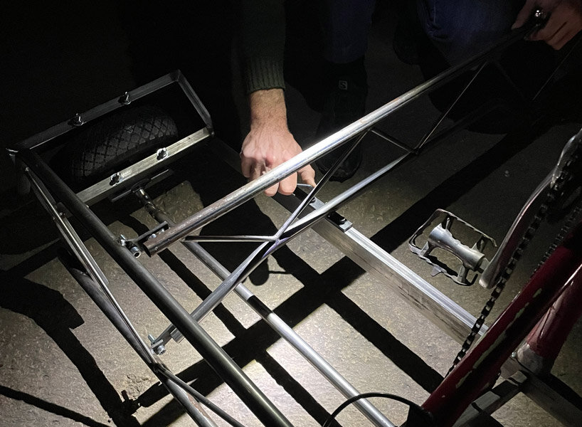 a bike inside a tunnel: artist fernando abellanas pedals through a sewer with ‘enlace’