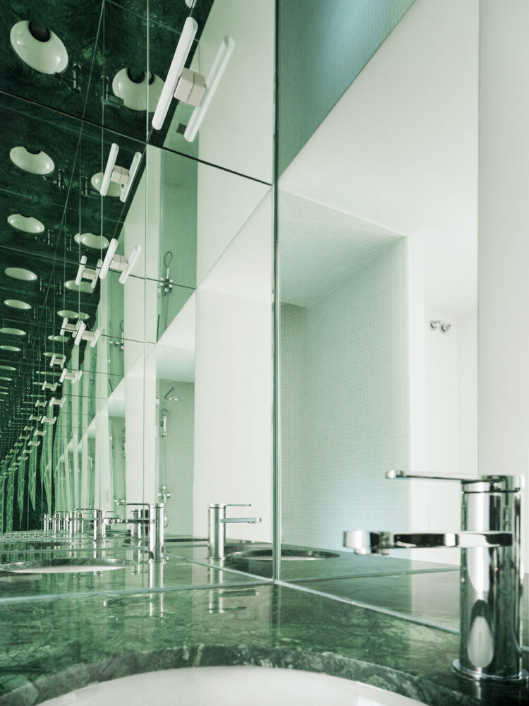 the mirrors create an intricate visual effect in the bathroom