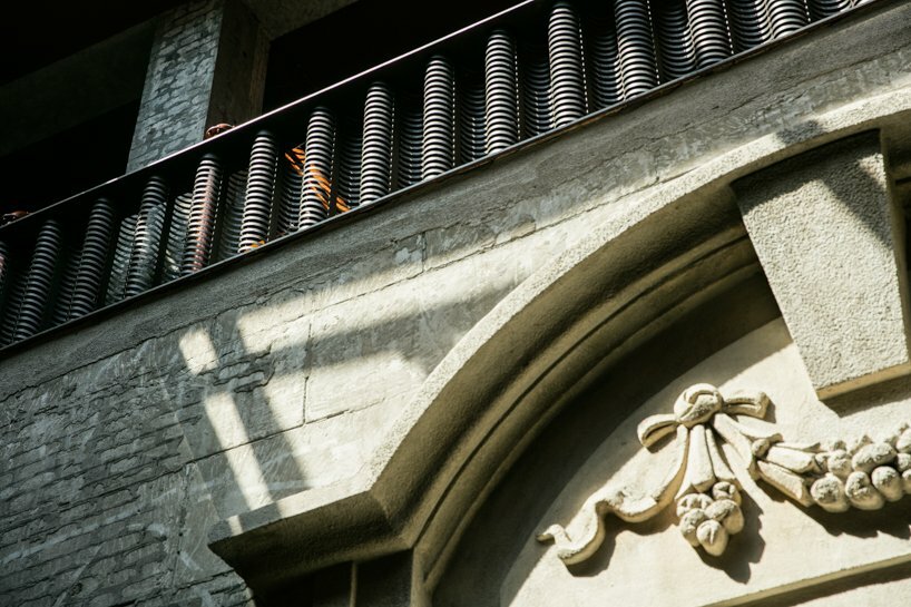 exposing the rough-textured cement exposed after the old wall finishing is removed 