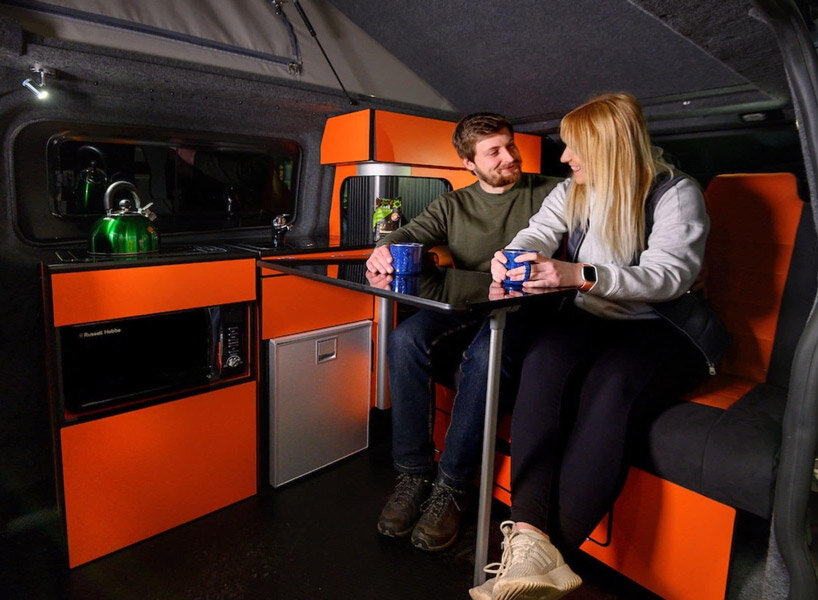 solar panels charge the new and spacious ford camper, making it fully electric