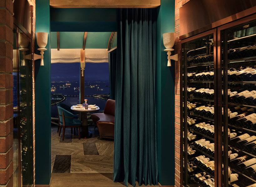 sky-high ‘the cellar’ by andré fu studio seats 28 diners and holds 400 premium wine labels